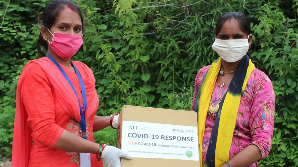 two female beneficiary taking her covid 19 vacinaton kit, at mount vallery development association in tehri garhwal's ngo